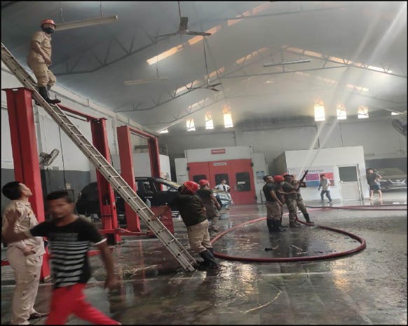 Fire personnel dousing the fire that broke out in the garage of Nilli Nissan Showroom in Dimapur on September 5.